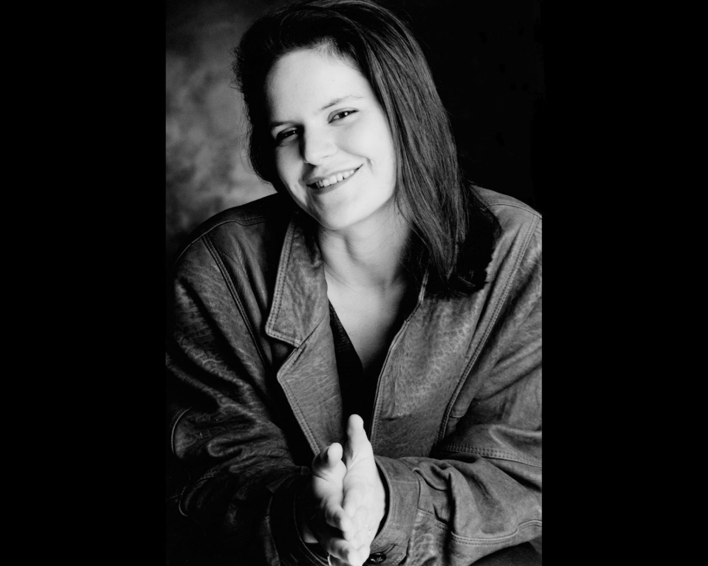 professional portrait of a young woman wearing a leather jacket